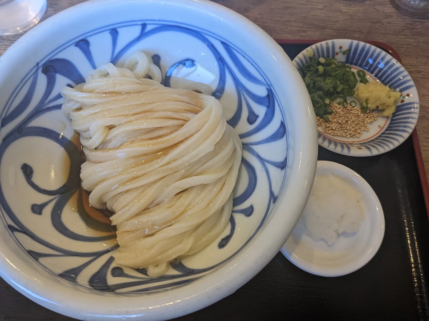 Glossy bukkake udon with a small amount of sauce and condiments